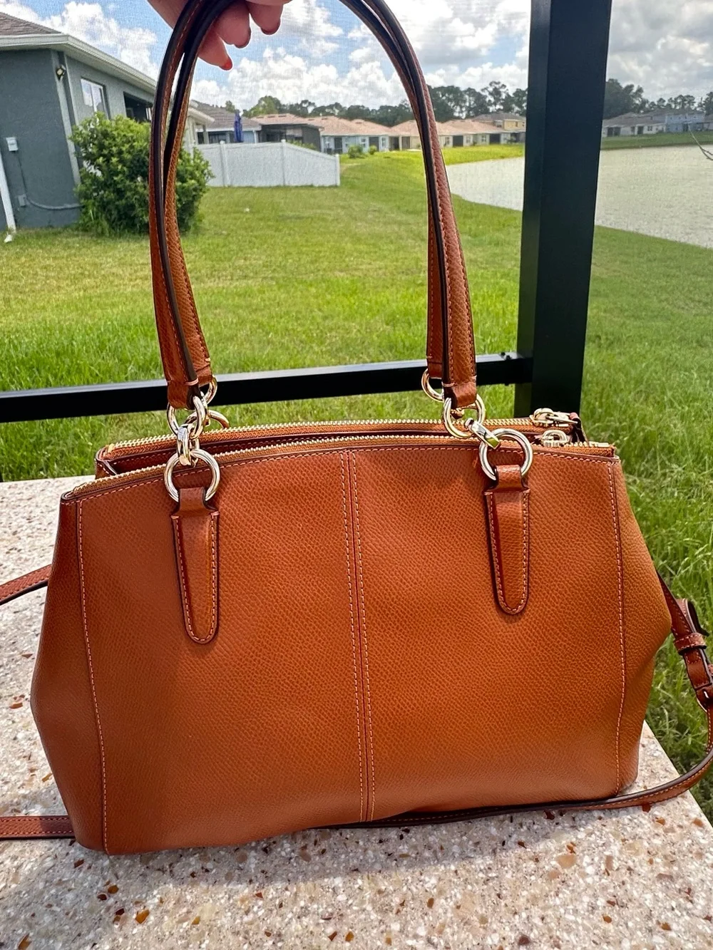 Coach Christie Carryall in a brown, textured leather with gold-tone hardware